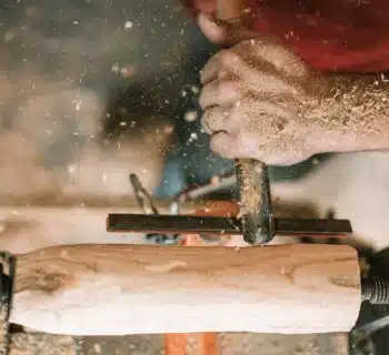 person holding gray metal tool