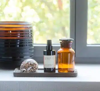 a window with a bowl of food and a bottle of liquid