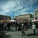 a large group of people standing in a plaza