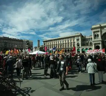 a large group of people standing in a plaza