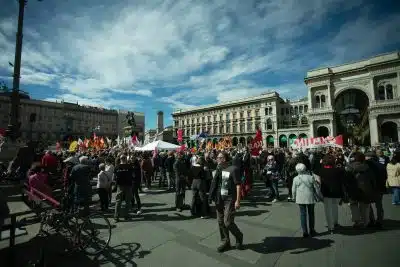 a large group of people standing in a plaza