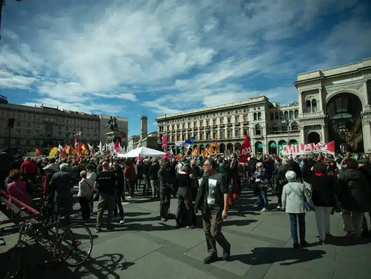 a large group of people standing in a plaza